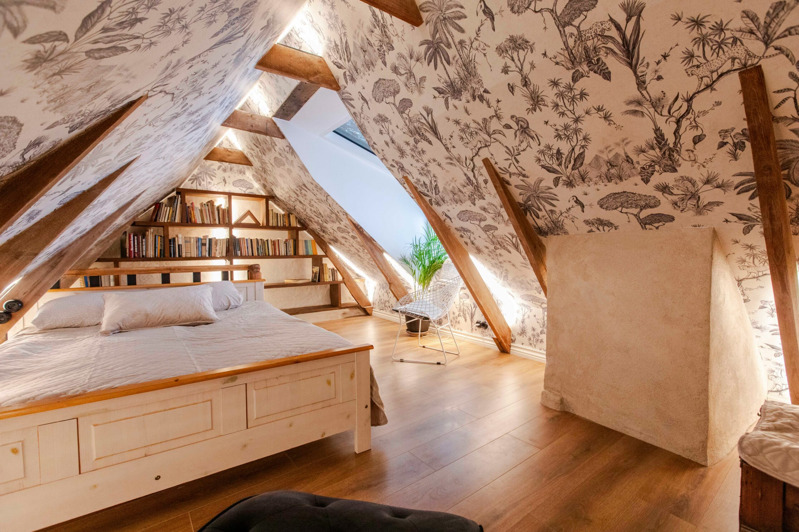 Attic conversion featuring ceiling paint, wall paint, and custom shelving by general contractor residentia