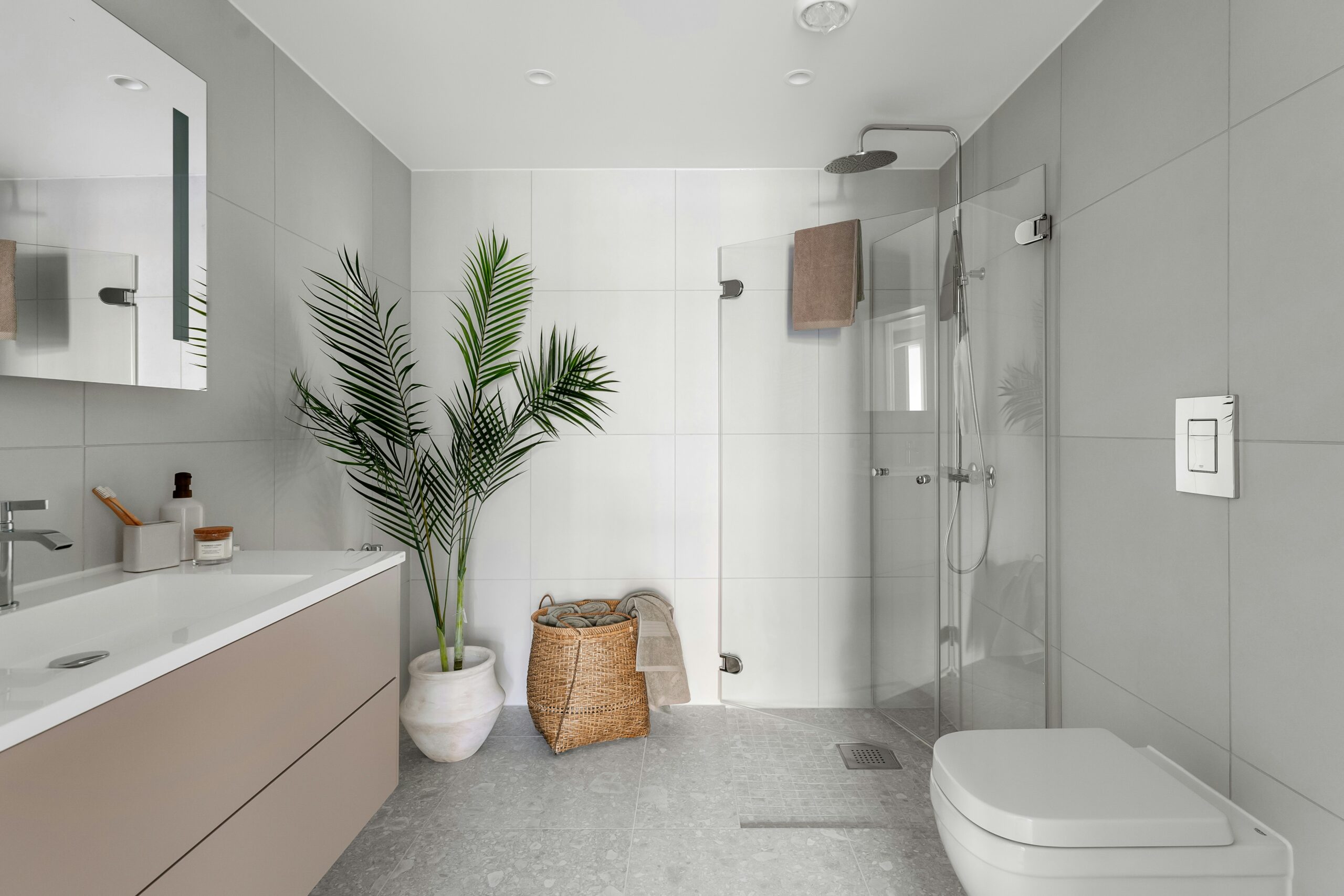 Coastal-inspired walk-in shower with breezy glass enclosure.