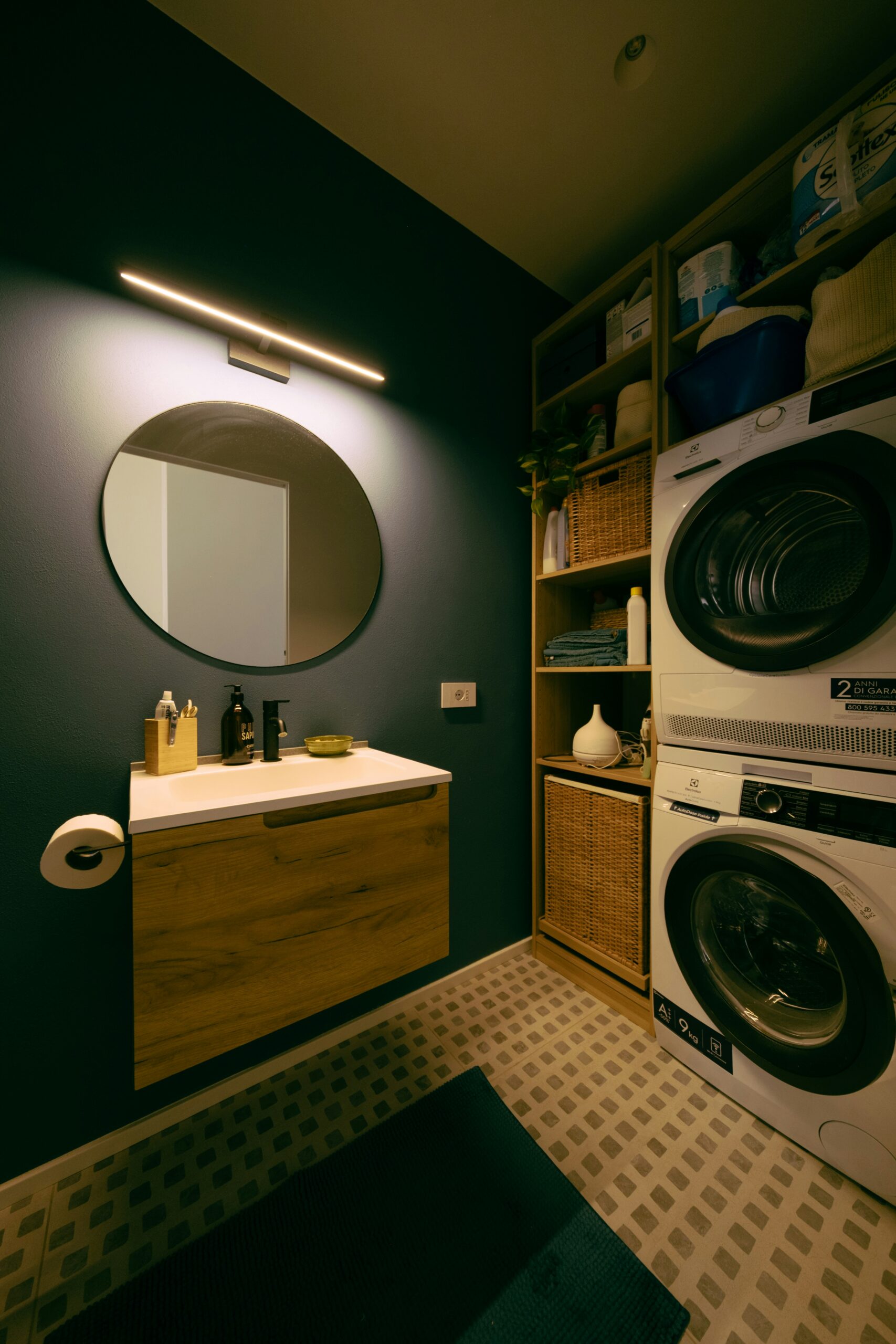 Laundry room remodeling with tile flooring and floating cabinets — a clean, functional upgrade.
