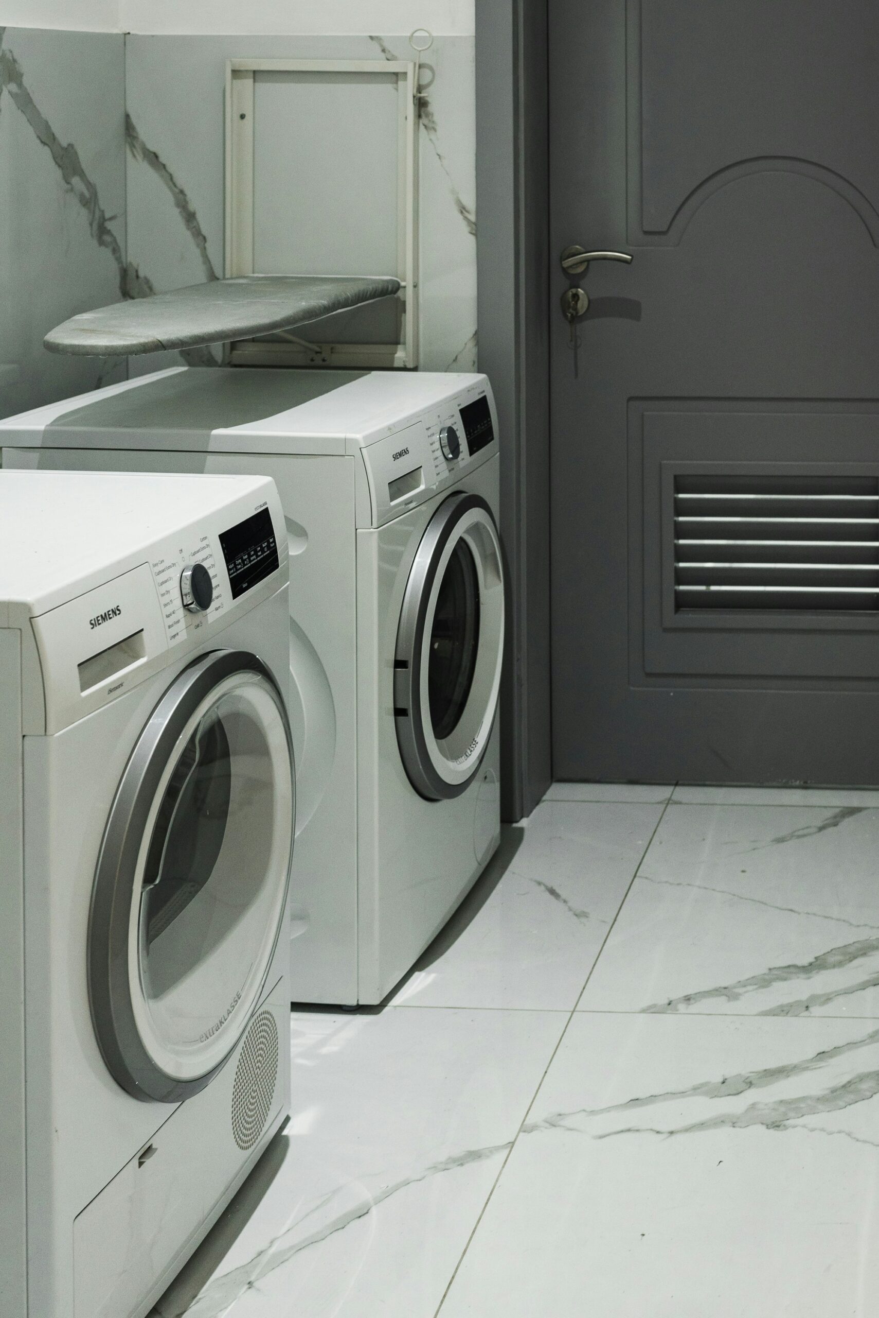 Tile installers near me added durable tile flooring to this laundry space